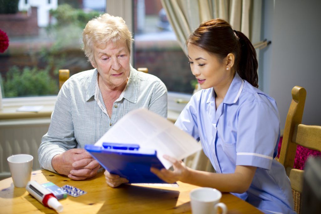 A care worker reviewing information with an older person